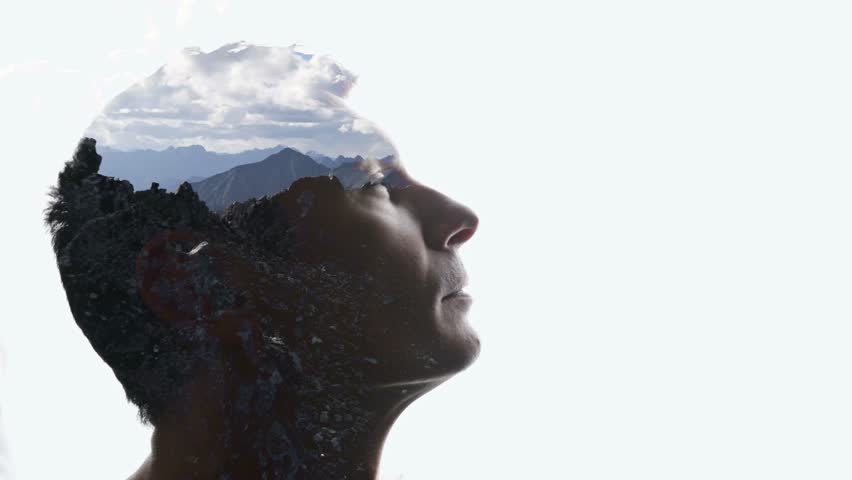 Isolated combination of the silhouette of a man face and a landscape with mountains. Concept of the connection between man and nature