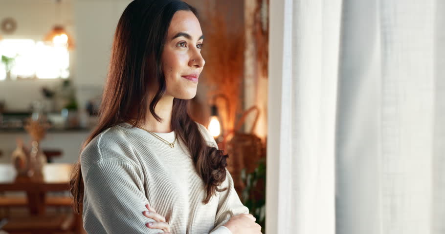 Thinking, window and woman in house, relax and happiness with thoughts, curtains and wonder in living room. Person, apartment and girl with daydreaming, start day and morning with decision in lounge