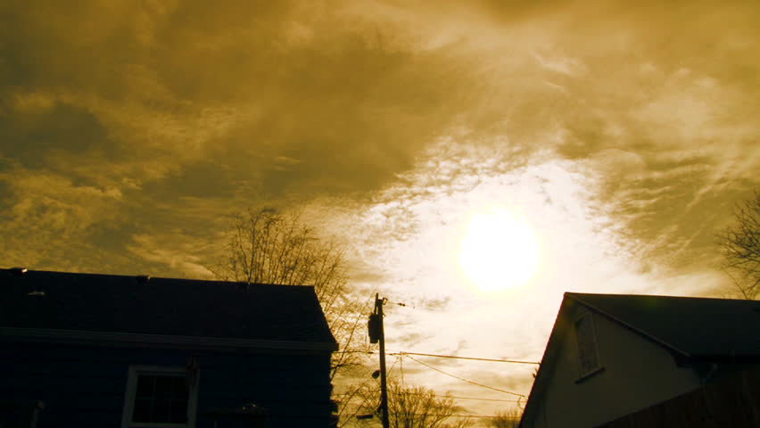 Time lapse vivid orange sunset over neighborhood houses.