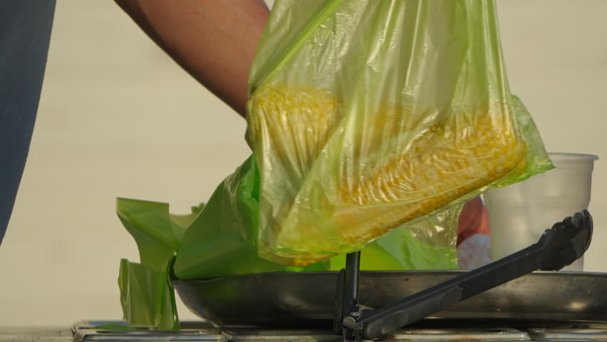 Corn, Plastic Bag, Hand - Person putting corn into a plastic bag