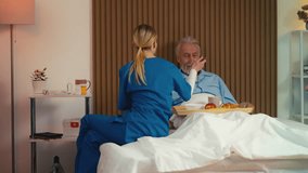 Upset senior male patient refusing to eat breakfast brought by nurse, care - Powered by Shutterstock - Get 15% off with code: PIKWIZARD15