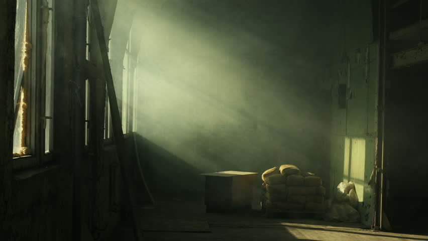Smoke in an old abandoned building with light rays coming in from the window