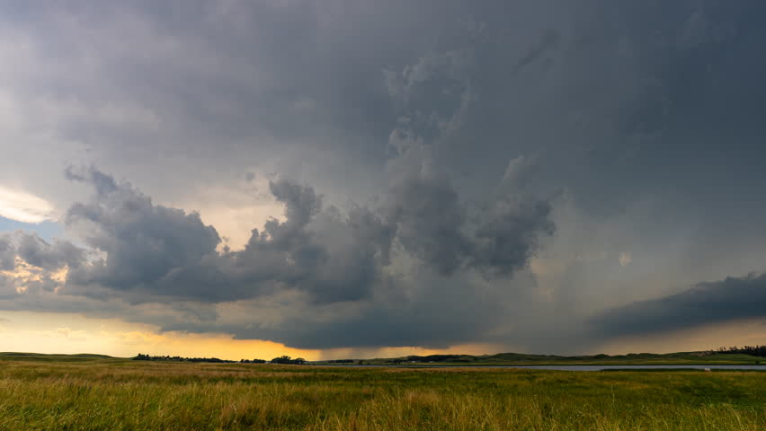 A striking time-lapse captures dark, threatening clouds looming ominously in a vast stormy scene, building with intensity.