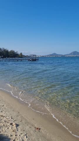 Praia das Andorinhas, Iguaba Grande, Rio de Janeiro, Brazil. A serene beach in Araruama Lagoon in a protected area, cristal clear waters, native vegetation and a tropical charming scenery.