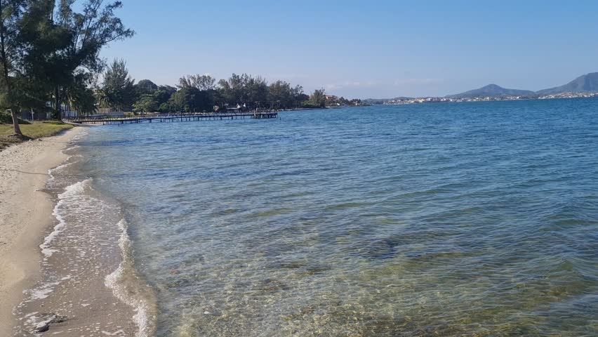 Praia das Andorinhas, Iguaba Grande, Rio de Janeiro, Brazil. A serene beach in Araruama Lagoon in a protected area, cristal clear waters, native vegetation and a tropical charming scenery.