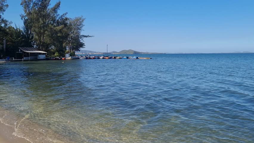 Praia das Andorinhas, Iguaba Grande, Rio de Janeiro, Brazil. A serene beach in Araruama Lagoon in a protected area, cristal clear waters, native vegetation and a tropical charming scenery.