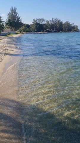 Praia das Andorinhas, Iguaba Grande, Rio de Janeiro, Brazil. A serene beach in Araruama Lagoon in a protected area, cristal clear waters, native vegetation and a tropical charming scenery.