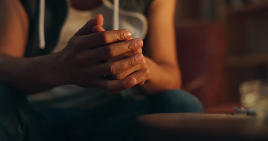 Anxiety, drug addict and hands of person in home with stress, worry and withdrawal symptoms. Mental health, substance abuse and closeup of gesture for rehabilitation, recovery or addiction at night