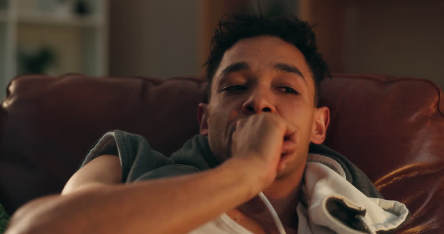 Man, biting nails and stress in home on sofa, panic and withdrawal symptoms with addiction at night. Person, paranoid and thinking with anxiety, frustrated and mental health with substance abuse