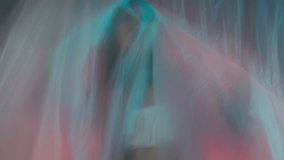 A woman in a pink blazer is trying to get out of plastic wrap  - Powered by Shutterstock - Get 15% off with code: PIKWIZARD15