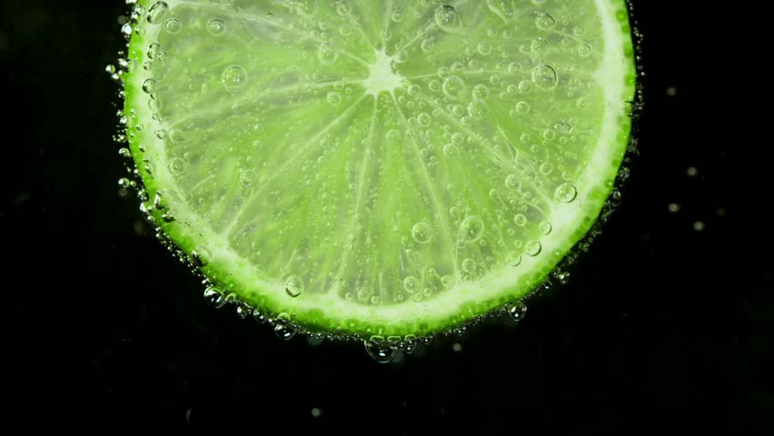 Super Slow Motion Shot of a Lime Slice in Water with Air Bubbles , Filmed with High Speed Cinematic Camera