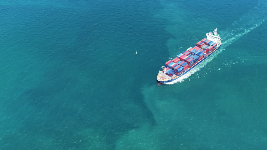 Cargo container ship carrying container and running in the ocean.  vessel go out from international container port customs shipyard sea port concept smart logistic service. top view of ship