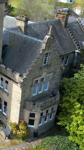close up aerial facade front medieval historic castle hotel scotland uk circling vintage travel attraction old landmark national hill kingdom architecture street tourist scenery monument