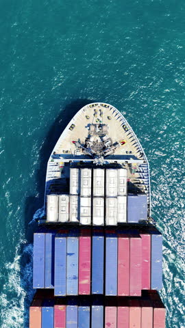 Cargo container ship carrying container and running in the ocean.  vessel go out from international container port customs shipyard sea port concept smart logistic service. top view of ship