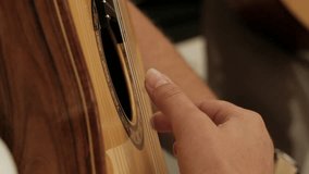 Close-up of musician's playing hands, guitarist plays the guitar. Professional guitarist plays guitar outdoors.  close up on music lessons. classical guitar teacher plays. hand close up - Powered by Shutterstock - Get 15% off with code: PIKWIZARD15