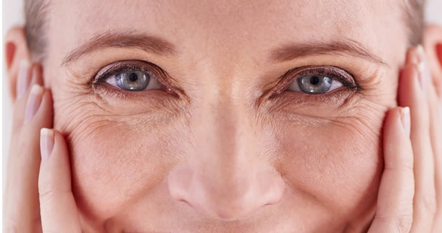 Beauty, eyes and transformation with mature woman closeup in studio for cosmetic skincare treatment. Aging, change or portrait and happy person at salon or spa for before and after dermatology