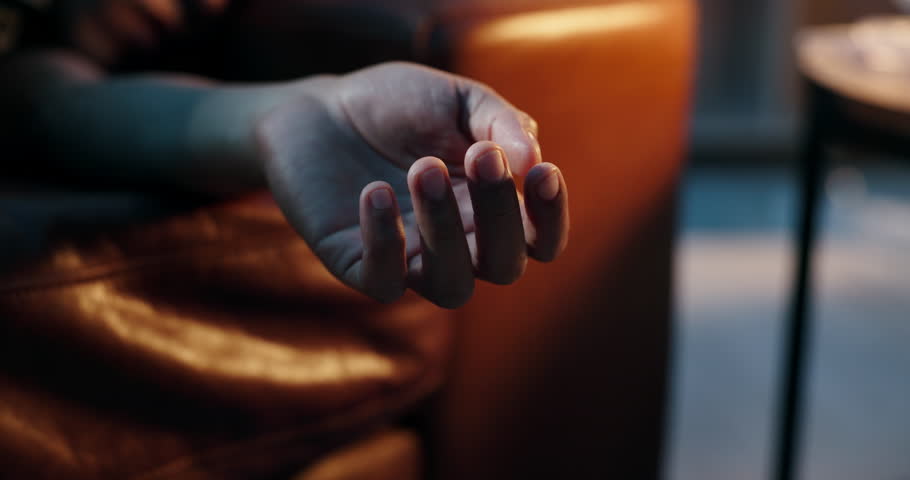 Drug abuse, death and hand of person on sofa with ambulance for medical emergency, crisis and accident. Substance abuse, dark home and closeup with siren lights for overdose, addiction and help