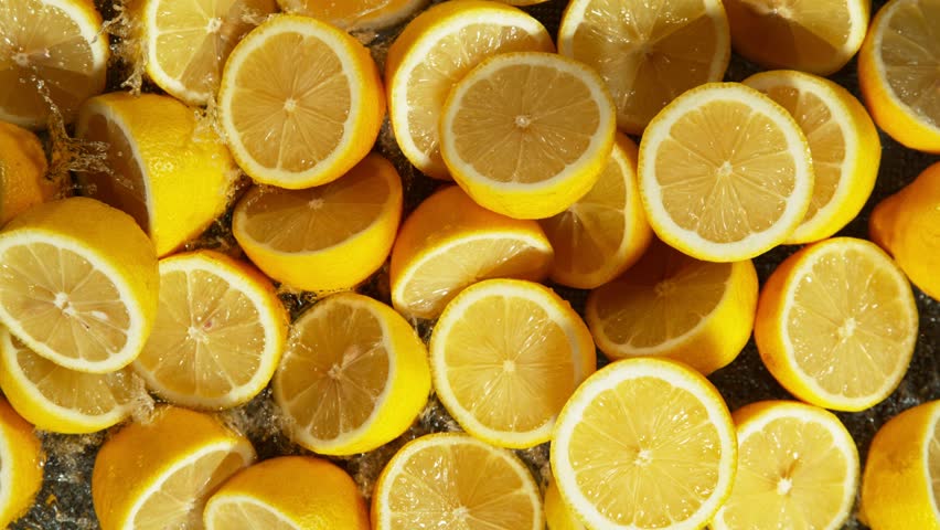 Super Slow Motion Shot of Splashing Fresh Lemons . Filmed on High Speed Cinematic Camera at 1000fps .