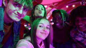 Happy group of teenagers taking a selfie together in a vibrant arcade setting, smiling and having fun. Group of Teenagers Smiling and Posing for a Fun Selfie at the Arcade - Powered by Shutterstock - Get 15% off with code: PIKWIZARD15