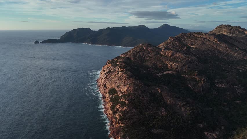 Wide panoramic aerial view over the Freycinet mountains and the waters of Wineglass Bay.