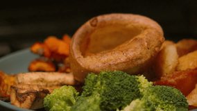 British Roast Dinner Meal with Gravy Beng Poured in Yorkshire Pudding in Slow Motion with Vegetables including Parsnips, Roast Potatoes, Broccoli, Carrots 4K - Powered by Shutterstock - Get 15% off with code: PIKWIZARD15