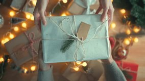 Top view of hands of woman giving Christmas present gift handmade to her friend, New year day and merry Christmas celebration and congratulation - Powered by Shutterstock - Get 15% off with code: PIKWIZARD15