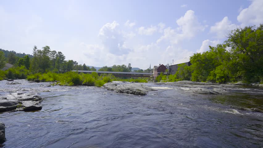 Littleton New Hampshire and the Riverwalk Covered Bridge over the Ammonoosuc River. 4k Video.