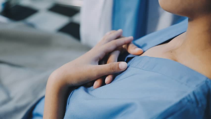 female doctor checking heartbeat of patient in the hospital.