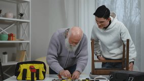 A heartwarming moment of a loving grandfather teaching his eager grandson invaluable DIY skills using various tools - Powered by Shutterstock - Get 15% off with code: PIKWIZARD15