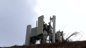 Big grey white 5G tower with blue sky background radiation kills us in Playa del Carmen in Mexico. - Powered by Shutterstock - Get 15% off with code: PIKWIZARD15