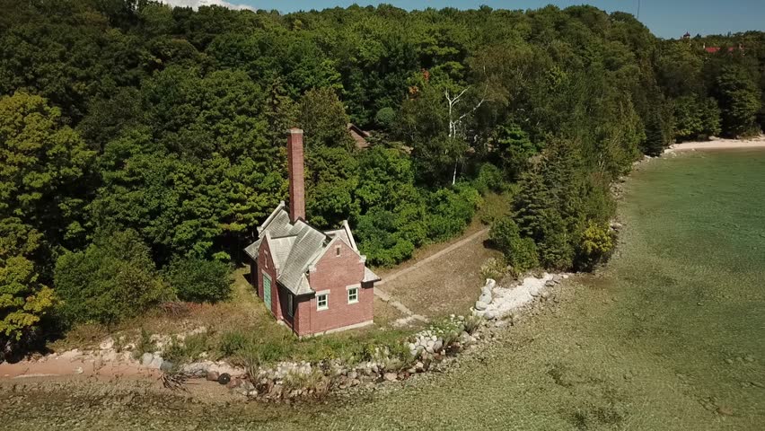 Crystal Clear Water of Lake Michigan at Beaver Islands Lighthouse and Fog Signal featuring white sand beaches