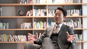 Video of an image of a cool president sitting in a chair and speaking in an interview, etc.	 - Powered by Shutterstock - Get 15% off with code: PIKWIZARD15