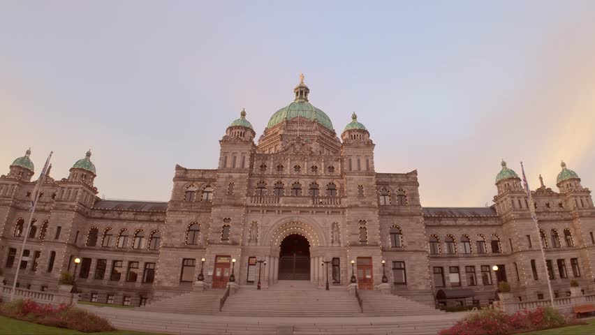 The imposing facade of the British Columbia Parliament Buildings, with its distinctive green dome and symmetrical design