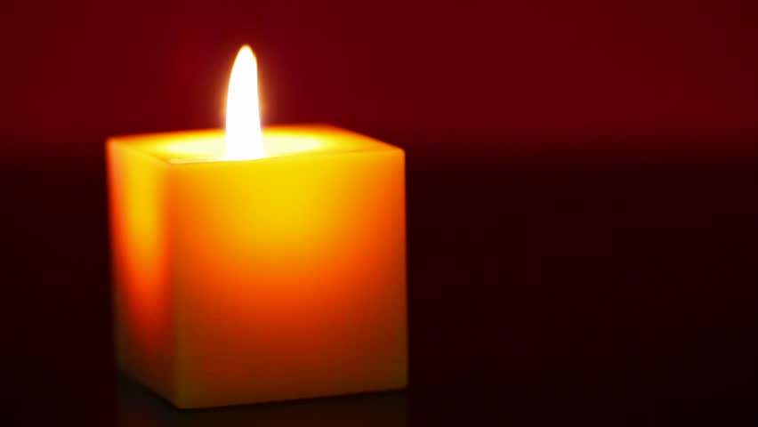 burning candle against red background Stock Footage Video (100% Royalty