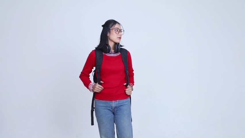 an Asian woman wearing a red dress is looking at the camera and smiling, medium shot