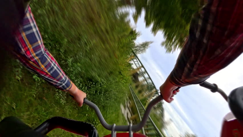 A thrilling front seat POV of a high-speed motorbike roller coaster, capturing the adrenaline-pumping twists, turns, and rapid accelerations as the ride races through the track