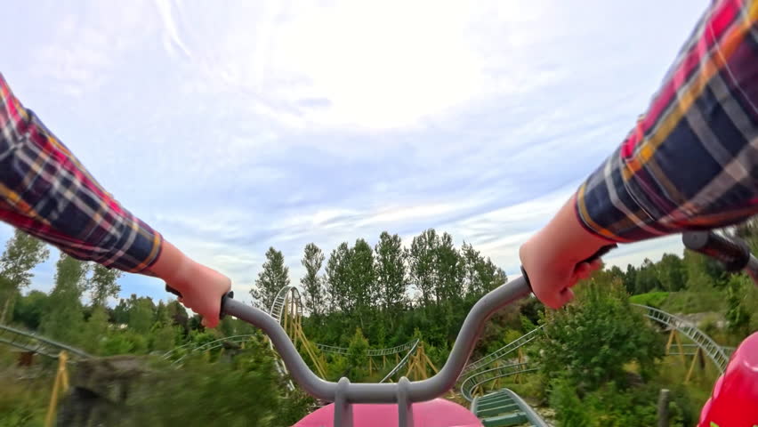 A first-person motorbike roller coaster experience in an amusement park, capturing the excitement of each twist and turn