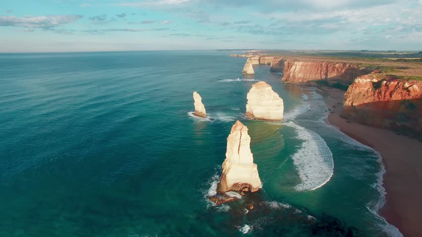 The Twelve Apostles along Great Ocean Road in Victoria, Australia. Port Campbell National Park on a beautiful sunrise, aerial view. Slow motion.