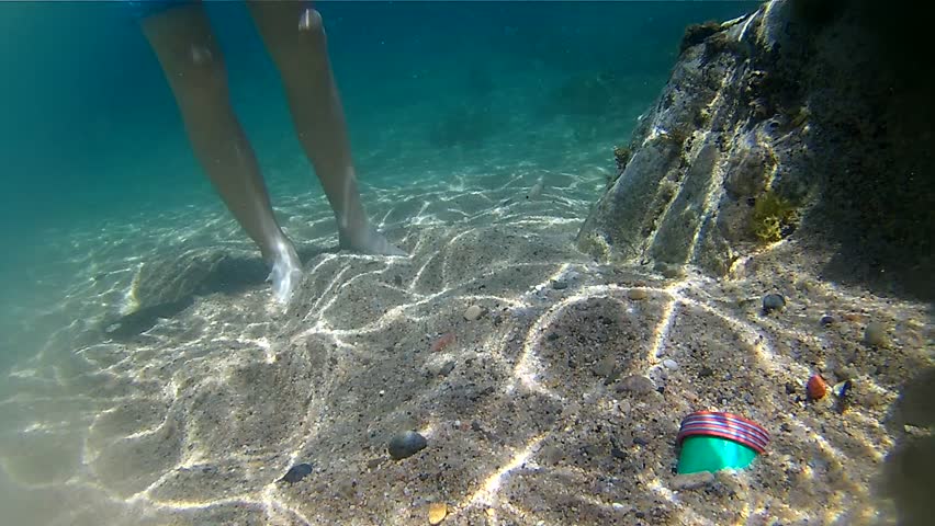 grapping a bottle under water