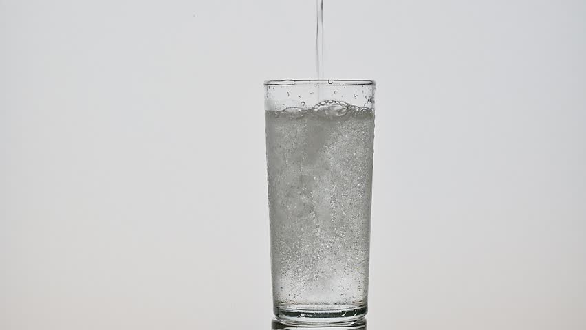 Cold water is poured into the glass cup.