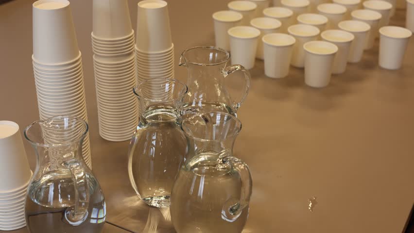 Clean water and cups on the table