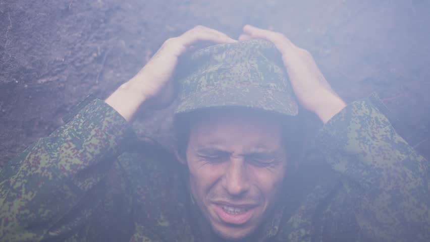 A soldier in a trench during a war under artillery fire