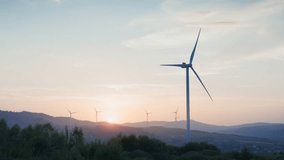 Camera view of beautiful field view with large wind turbines. Wind blowing on blades of wind farm. Countryside. Electricity production. Farming land. Wind power. Concept of energy production industry. - Powered by Shutterstock - Get 15% off with code: PIKWIZARD15