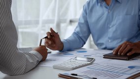 Two businessmen examine financial data while discussing insights and strategies in a corporate office setting - Powered by Shutterstock - Get 15% off with code: PIKWIZARD15