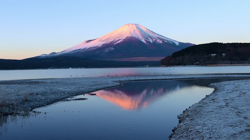 Sunrise at Fuji mountain in winter with reflection of Fujiyama in lake Kawaguchi, symbol of Japan, tourist destination in Japan