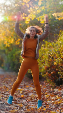 Hello autumn. Full length portrait of fit woman in fitness clothes in the park workout.