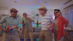 Group of Asian senior friend having evening party in living room at home. Mature elderly man and woman having fun, dancing with cool music while celebrate weekend reunion gathered together in house. - Powered by Shutterstock - Get 15% off with code: PIKWIZARD15