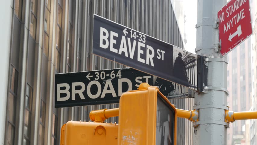 New York City, United States. Manhattan Downtown Financial District. American Wall street. Broad and Beaver corner road sign. Stock Exchange, USA Stock Market. Traffic light on crossroad intersection.