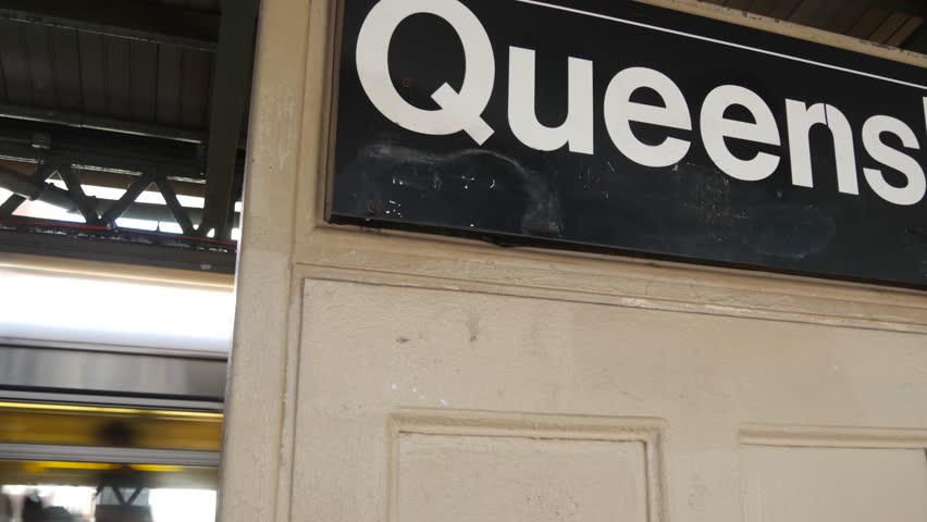 New York City subway station interior, underground metropolitan platform sign. Metro train, railway passenger public transport, United States. Queens text signboard. Queensboro, Long Island, NYC.
