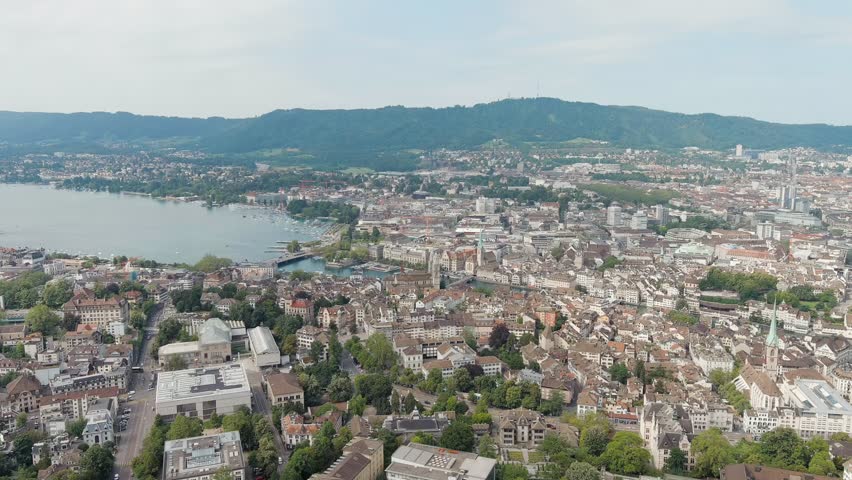 Dolly zoom. Zurich, Switzerland. Panorama of the city overlooking Lake Zurich. Summer day, Aerial View, Departure of the camera